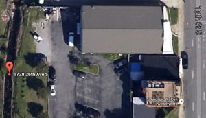 Google Maps aerial view of Dorothy McDaniel building, existing parking and grassy area to be converted to parking for a building tenant. 